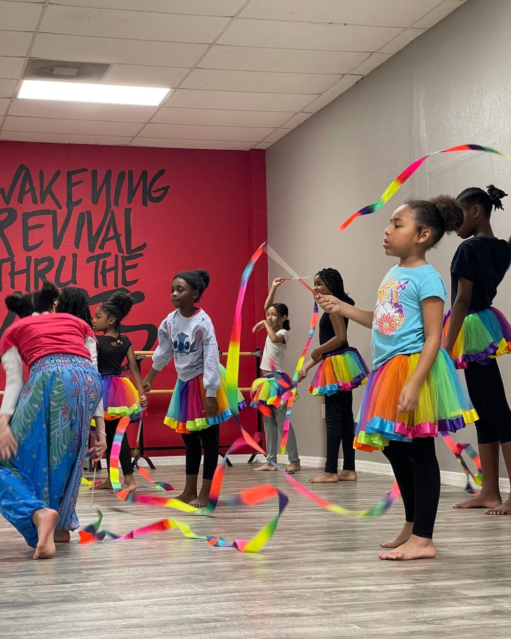 HOTAI Kids Academy students dancing with rainbow streamers